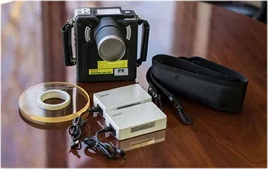 Image-Vet FleXX kit with battery packs, strap and charger laid out on a table